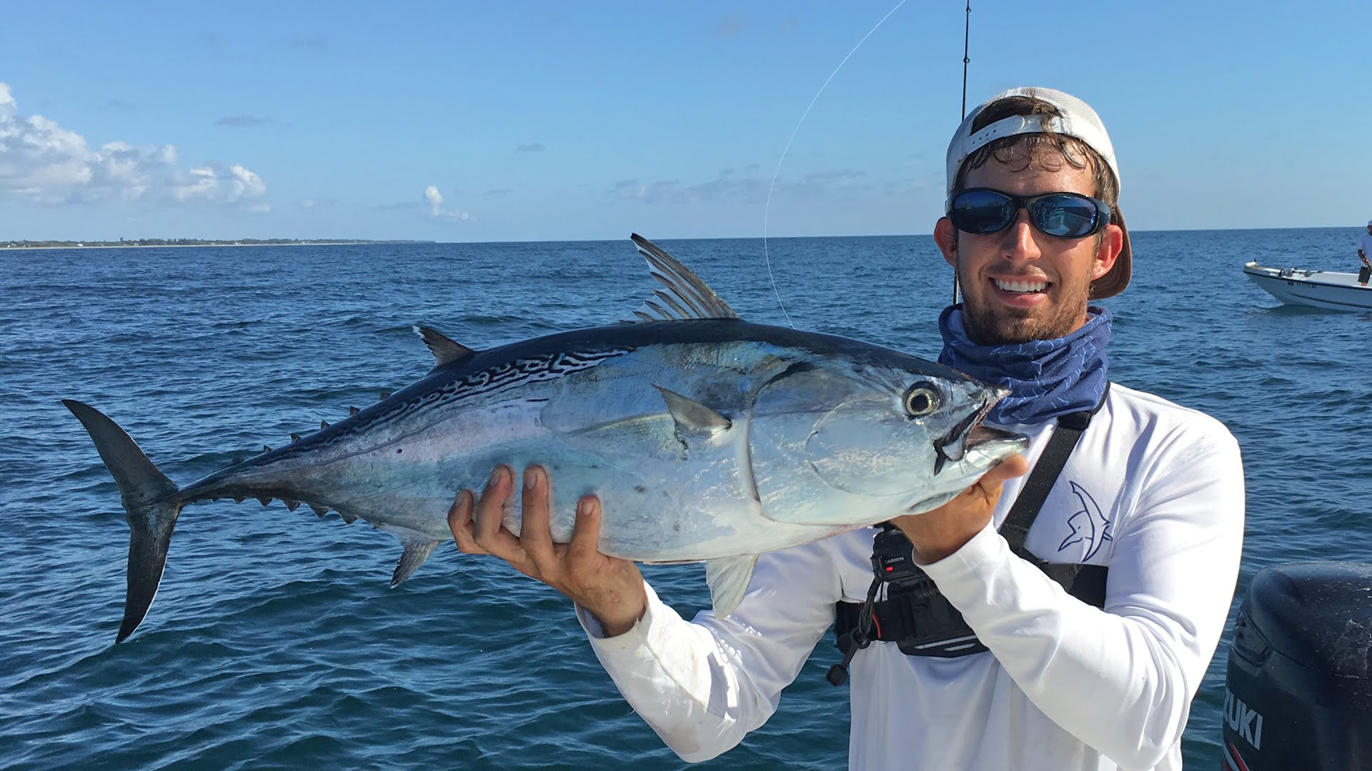 Man holding a Bonito fish.